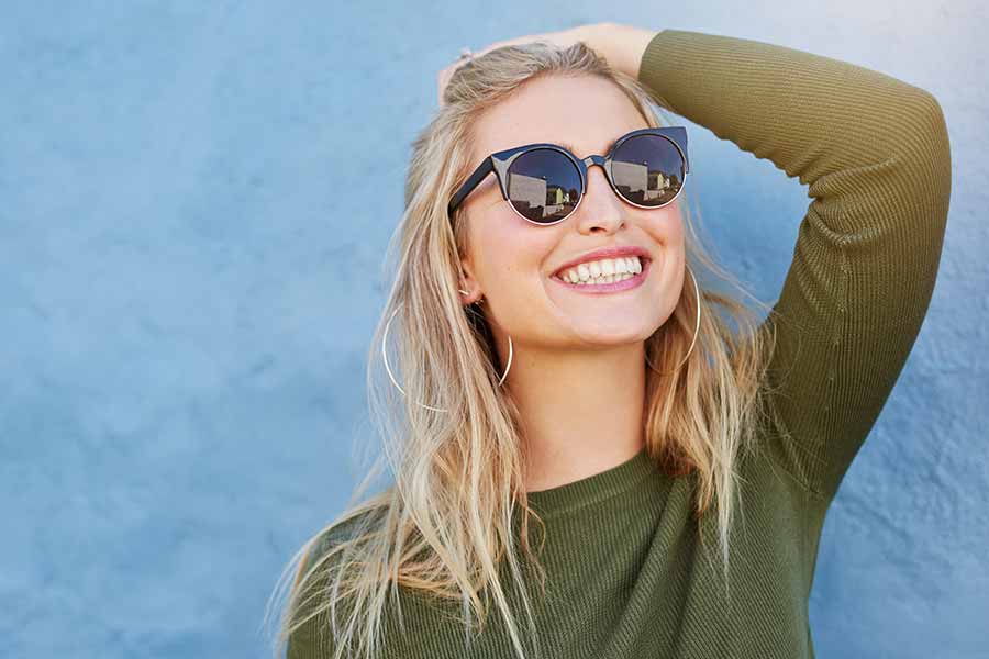 Woman wearing sunglasses and smiling